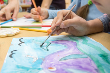 Hand draws a drawing in a school of drawing