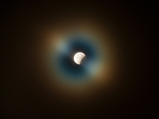 Full moon partial eclipse surrounded by a corona (aureole) 