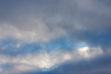 Morning sunrise. Blue sky with clouds. The morning sun illuminates the clouds.