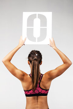 fit girl holding the letter o