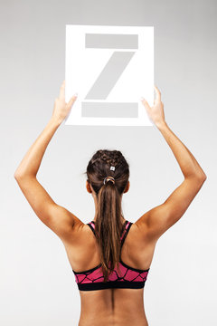 fit girl holding the letter z