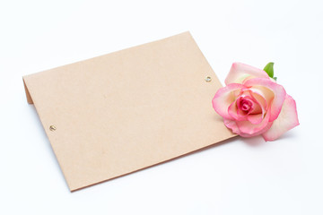 pink rose and envelope on a white background, an envelope for the inscription.