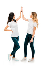 happy young women giving high five and smiling each other isolated on white