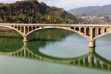 Fototapeta na wymiar ancient stone bridge over the Bailong River, China.