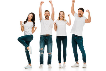 Obraz premium excited young friends shaking fists and smiling at camera isolated on white