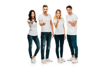 Obraz premium serious young people standing together and pointing at camera isolated on white