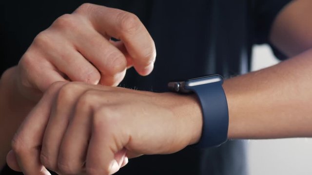 Smartwatch on male's hand on isolated white background. Man using smart watch
