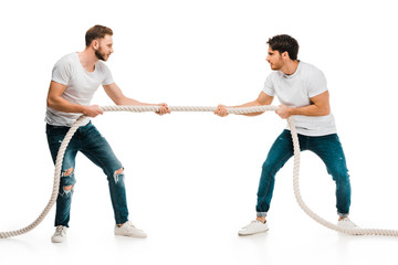 young men pulling rope and playing tug of war isolated on white