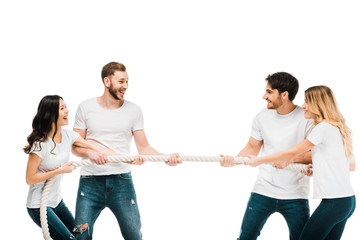 happy young couples pulling rope and playing tug of war isolated on white - obrazy, fototapety, plakaty