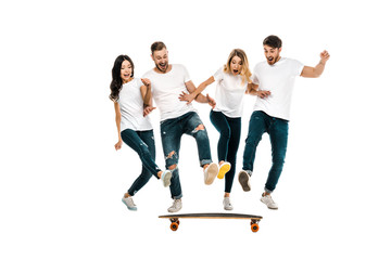 happy young friends having fun with skateboard isolated on white