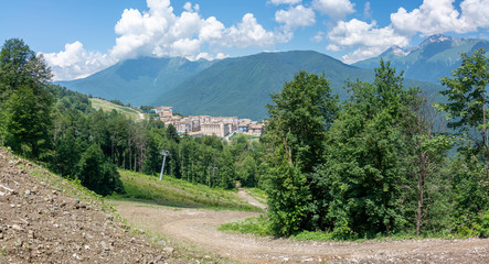View of the hotel complex in the mountains covered with green forests