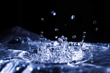 Water drops splashing on acoustic membrane. A lot of drops in air. High frequency of sound waves....