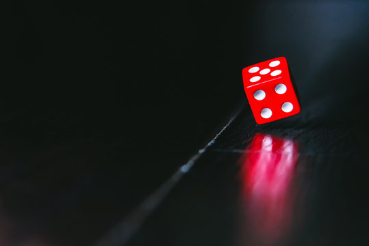 Close - up of the dice on a dark background.