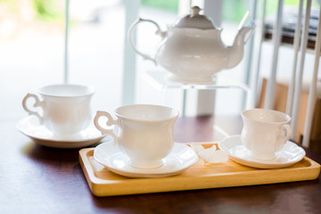 Obraz na płótnie Canvas cup and kettle white ceramic on shelves