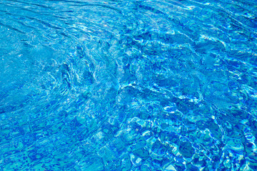 Blue pool water with sun reflections