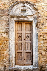 Fototapeta na wymiar Texture of an old wooden door in Italy