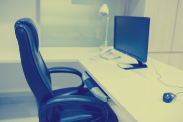 the computer is on the table in a bright interior.