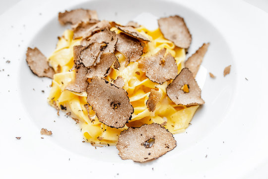 Dish of delicious italian pasta with truffle mushroom chips, on the table in luxury restaurant.