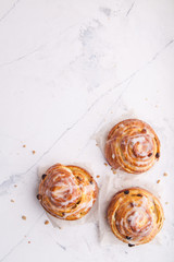 Fototapeta na wymiar Cinnamon rolls buns on a white marble background. Bakery concept. Breakfast and brunch. Flatlay. Overhead. Copy space