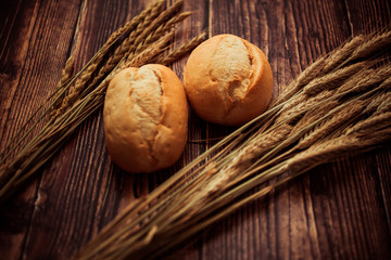 Still life with bread. Bread, buns, ears of wheat, dough, flour. 