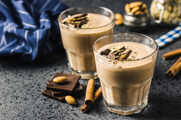 Chocolate almond milk oat smoothie on dark background. Selective focus, space for text.