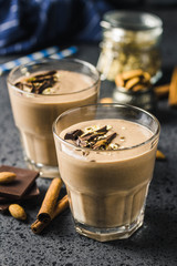 Chocolate almond milk oat smoothie on dark background. Selective focus, space for text.