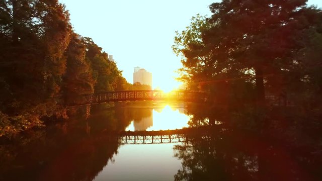 Aerial of Man Crossing a Bridge at Sunrise