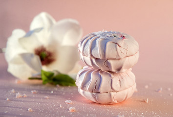 pink sweet marshmallow, Magnolia flower on beige background, dessert, food