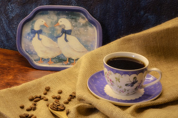 Coffee on brown background with coffee beans. Morning coffee on blue cup 