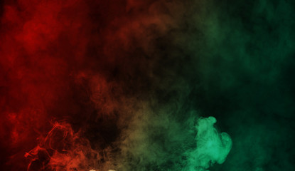 Abstract red vs green smoke steam moves on a black background . The concept of aromatherapy