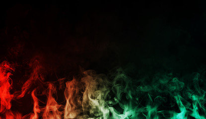 Abstract red vs green smoke steam moves on a black background . The concept of aromatherapy