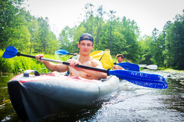 Man kayaking in wild river