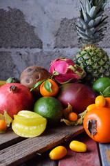 Mix of ripe tropical fruits with avocado, mango, coconut, carambola, banana, kumquat, pitahaya, kiwi Superfood background Vegetarian food