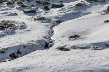 Way of ascent to the lagoons of Peñalara in the mountain range of Madrid covered by snow.