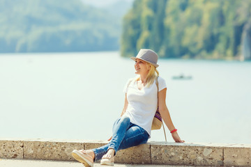 Rest on a mountain lake near Neuschwanstein. girl is sitting, enjoying a rest in the middle of the...