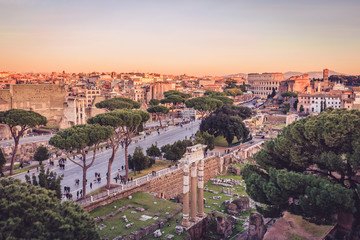 Fototapeta premium Foro di Cesare and Colosseum in the background in golden hour light