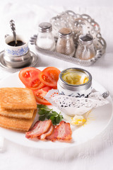 Breakfast with egg, bacon, croutons and coffee