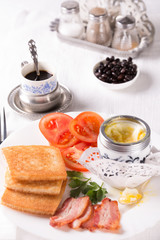 Breakfast with egg, bacon, croutons and coffee