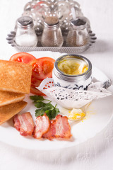 Breakfast with egg, bacon, croutons and coffee