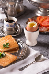 Breakfast with croutons, poached egg and coffee. Vintage dishes.