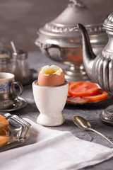 Breakfast with croutons, poached egg and coffee. Vintage dishes.