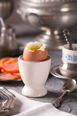 Breakfast with croutons, poached egg and coffee. Vintage dishes.