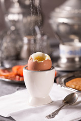 Breakfast with croutons, poached egg and coffee. Vintage dishes.