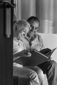 grandparents reviewing their album of family photographs