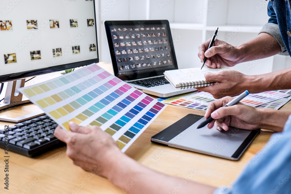 Fototapete two colleagues creative graphic designer working on color selection and drawing on graphics tablet a