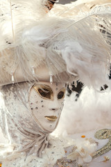 Portrait of unknown woman wearing ornate white venetian outfit at carnival party