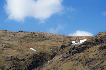 Snow drift at head of steep mountain valley in moorland (Lake District)