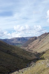 Valley in Lake District (Cumbria, UK); green farmland in distance