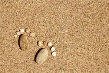 Fototapeta na wymiar Feet of a family of stones on the sea