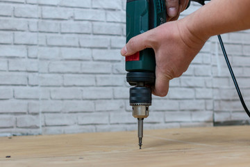 Man tightens the screw during the repair